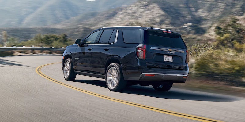 Chevy Tahoe rear view drives along the road