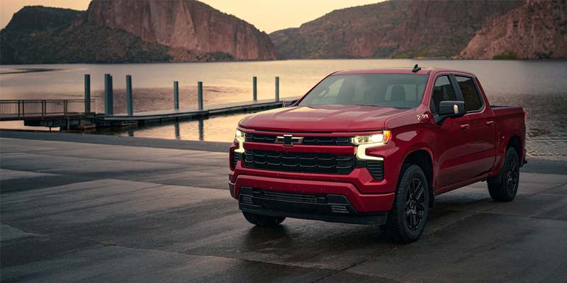 red Chevrolet Silverado-1500 parked near river