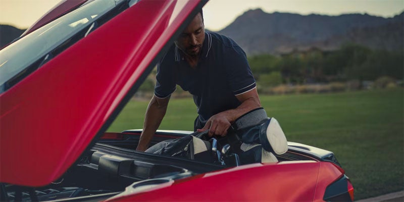 Man under hood of 2025 Chevrolet Corvette Stingray